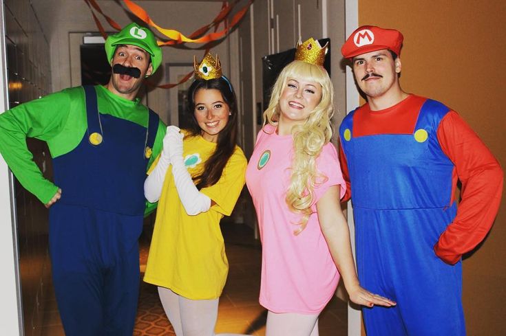 three people in mario bros costumes posing for a photo with one woman and two men