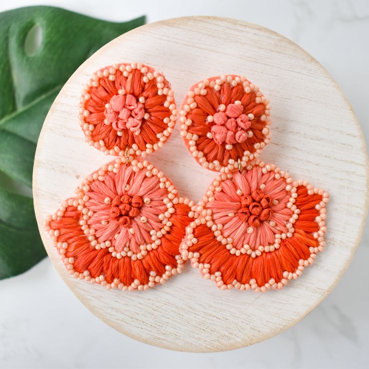 Add a pop of color to your style with these Coral Raffia Flower Drops. These earrings are lightweight, making them comfortable to wear all day. Perfect for adding a touch of fun and vibrancy to any outfit. Made with high-quality materials for durability and style. Lead and Nickel free. Bohemian Flower Earrings For Vacation, Bohemian Flower Earrings For Summer Vacation, Handmade Bohemian Flower Earrings For Vacation, Bohemian Summer Flower Earrings For Vacation, Trendy Red Flower Earrings For Summer, Casual Beach Earrings For Spring, Adjustable Multicolor Flower Earrings For Summer, Adjustable Flower Earrings For Summer Vacation, Bohemian Flower Earrings For Summer