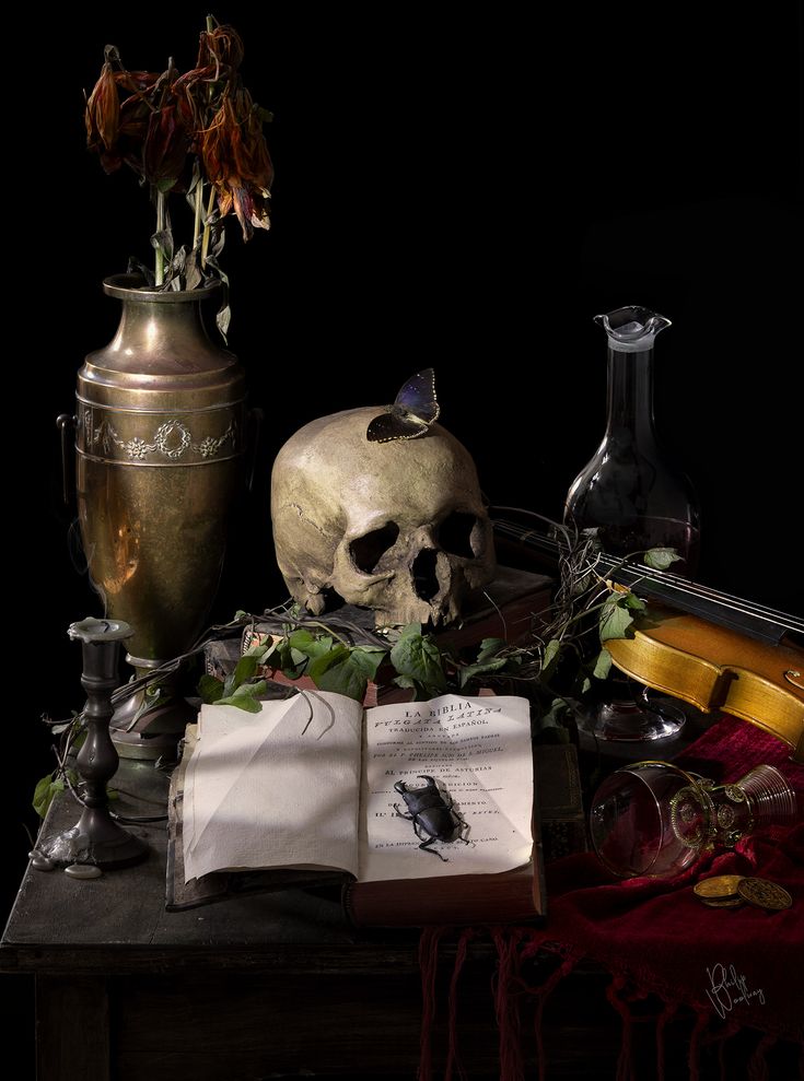 a table topped with books and vases filled with flowers next to a skull on top of an open book