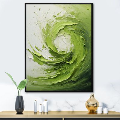 an abstract painting in green and white on a wall next to a vase with candles