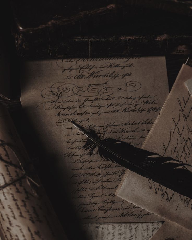 an old letter and quill resting on top of some other papers with writing written on them