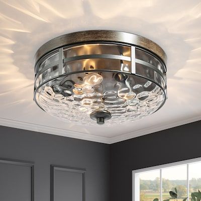 a ceiling light in a room with grey walls and white trimmings on the ceiling