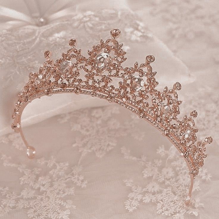 a tiara is laying on top of a white lace