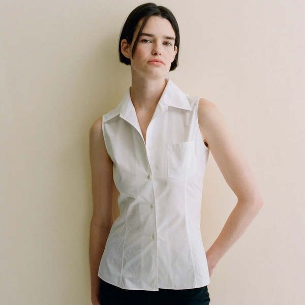 Flore flore's rosie sleeveless shirt is a slim fitted sleeveless shirt with a voluminous fold-over collar and a single front pocket. this structured piece has a straight hem small side vents and darts on the front and back. it also features real mother of pearl buttons.    the rosie sleeveless shirt is crafted from a heavier weight albini organic cotton fabric. albini is the leading luxury textile house for high quality shirting based in bergamo italy.    made in portugal. 100% organic cotton.    chest: 44cm; waist: 37cm; hips: 48cm; length: 63cm (measurements for size s).    care: wash with similar colors and mild detergent at or below 30°c. for stains use mild chemical free soap avoid household or chlorine bleaches. do not tumble dry but hang dry. iron low.    flore flore was founded in Conference Wardrobe, Textile House, Mari Giudicelli, Bergamo Italy, Luxury Textiles, Shoes Flats Sandals, Bergamo, Organic Cotton Fabric, Knitwear Tops