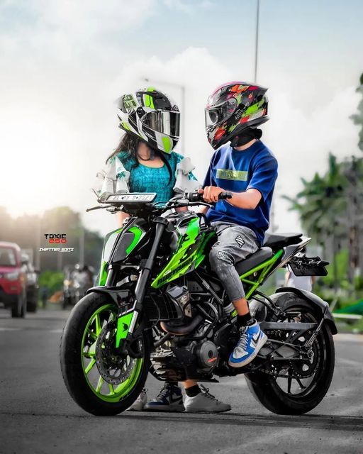 two people sitting on a motorcycle in the street