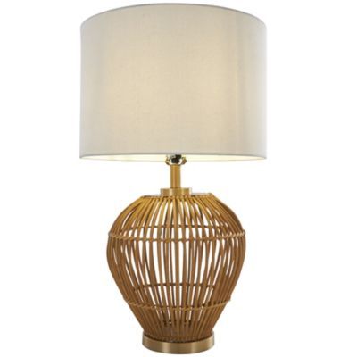 a table lamp with a white shade on the base and a gold metal cage design