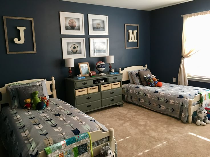 a bedroom with two twin beds and pictures on the wall