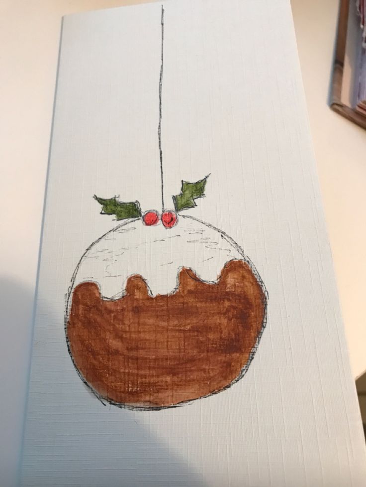 a drawing of a christmas pudding with holly leaves on it's top and two cherries hanging from the top