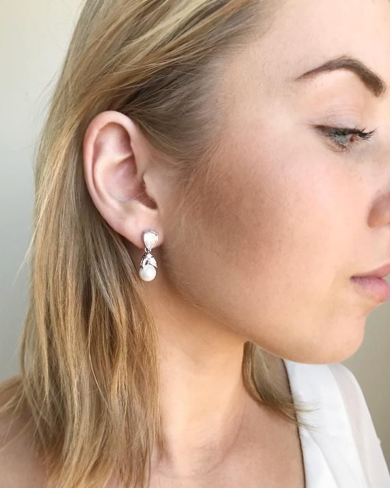 a close up of a person wearing earrings