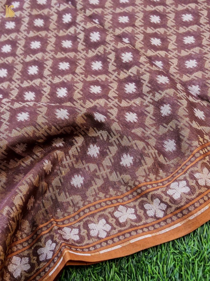 This ensemble from Khinkhwab features a meticulously crafted Pure Cotton by Kora suit. It includes a handwoven Kurta Fabric and a dupatta made from pure Kora cotton using intricate jamdani weaving. Bohemian Brown Traditional Wear With Pallu, Brown Cutdana Dupatta For Navratri, Brown Cutdana Embellished Dupatta For Navratri, Bohemian Cotton Unstitched Suit For Diwali, Brown Traditional Wear With Motifs For Festivals, Brown Traditional Wear With Traditional Patterns, Festive Brown Traditional Wear With Traditional Patterns, Designer Traditional Patterned Dupatta For Transitional Season, Designer Transitional Dupatta With Traditional Patterns