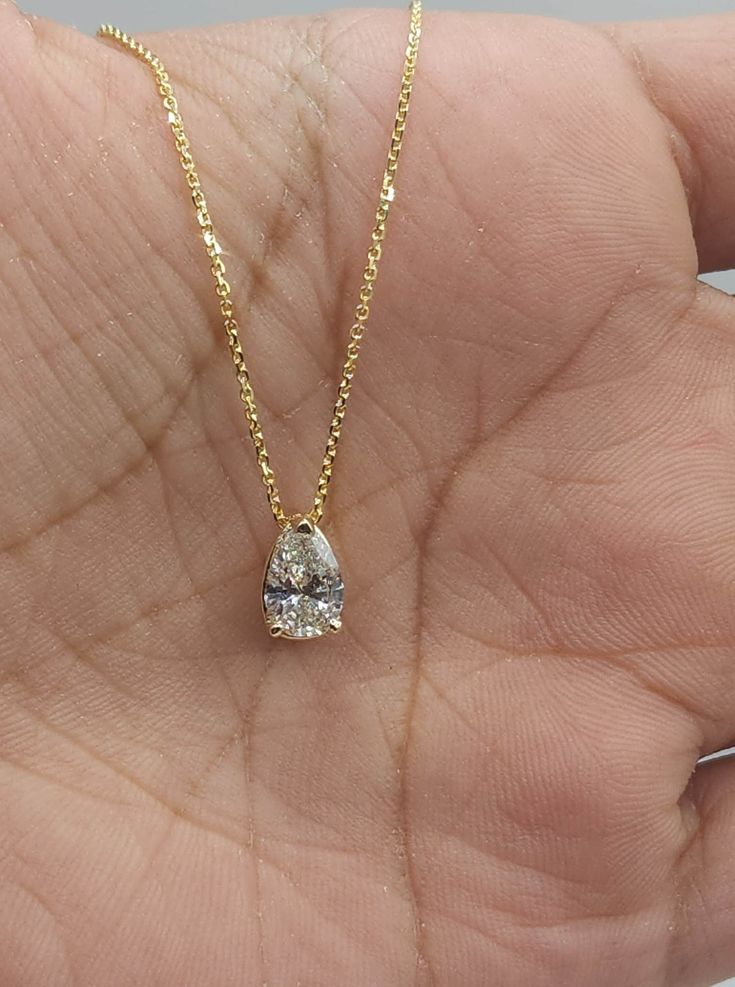 This is a beautiful Lab Grown diamond design pendant. It is set in real solid 14Kt Gold and the chain is 14Kt Gold as well.  You can choose if you want 14Kt White Gold, 14Kt Yellow Gold or 14Kt Rose Gold.  We have a lot of beautiful jewelry with natural diamonds. If any listing states "diamond" then it is a natural diamond. If the listing states "Lab Grown" it is a Lab Grown diamond. The chain goes through so that the diamond sits comfortably on you when you wear it. This is the perfect gift for Yellow Gold Pear-shaped Diamond Solitaire Necklace, Fine Jewelry 14k Gold Pear-shaped Diamond Necklace, 14k Gold Pear-shaped Diamond Necklace, Gia Certified Yellow Gold Teardrop Jewelry, Pear-shaped Diamond Necklace In 14k Gold, Pear-shaped 14k Gold Diamond Necklace, 14k Gold Pear-shaped Diamond Necklace For Anniversary, Anniversary 14k Gold Pear-shaped Diamond Necklace, Gold Solitaire Necklace With Brilliant Cut Pear-shaped