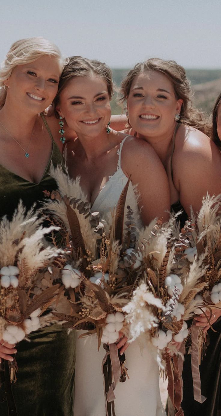 four bridesmaids pose with their bouquets in the desert