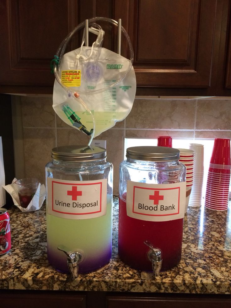 two jars filled with liquid sitting on top of a counter