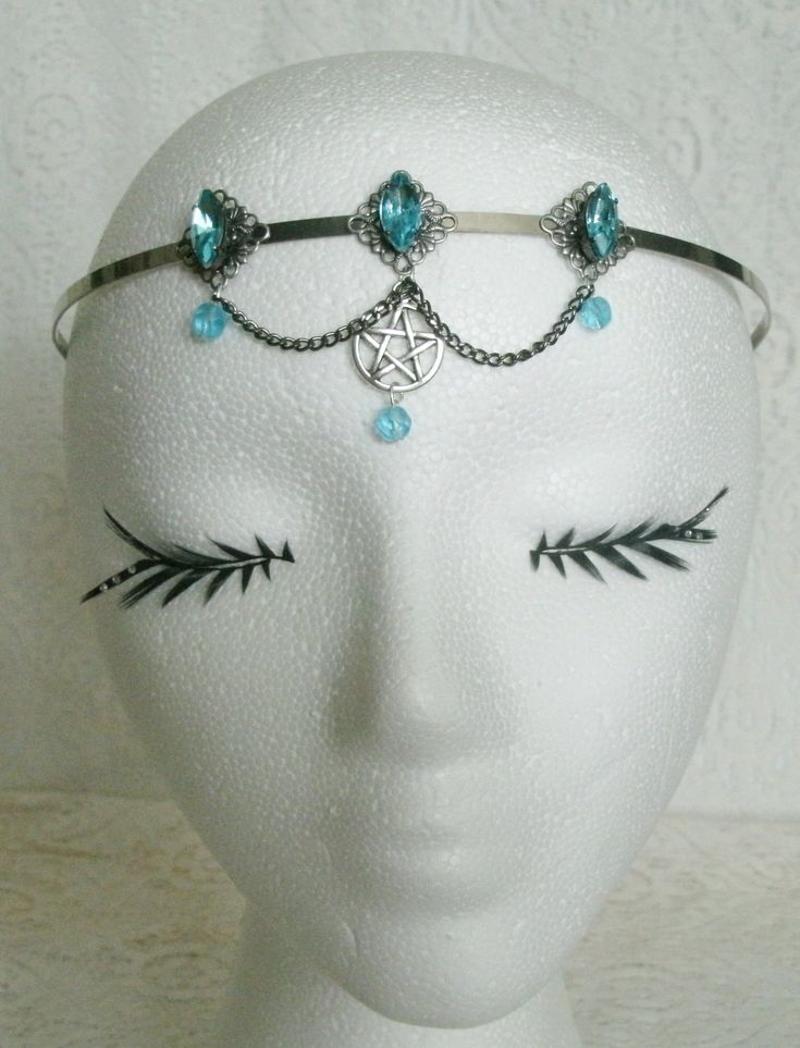 Blue Pentacle Circlet This beautiful circlet has three sterling silver plated filigree accents with aqua blue faceted glass settings, aqua blue glass bead drops, pewter silver pentacle and metal chain. An elegant headpiece. Adjustable. Adjustable Fantasy Jewelry For Festivals, Adjustable Fantasy Festival Jewelry, Gothic Blue Metal Jewelry, Blue Gothic Metal Jewelry, Adjustable Wire Wrapped Fantasy Jewelry, Silver Fantasy Jewelry For Festivals, Gothic Adjustable Body Jewelry For Festivals, Adjustable Blue Festival Headpieces, Adjustable Blue Headpieces For Festivals