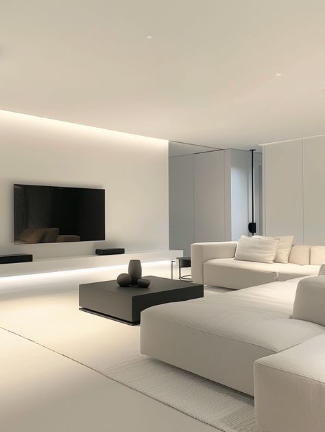 a living room with white furniture and a flat screen tv mounted on the wall above it