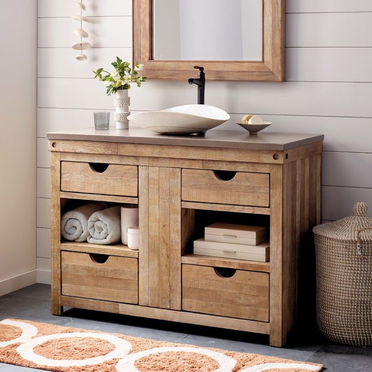 a bathroom with a sink, mirror and rug