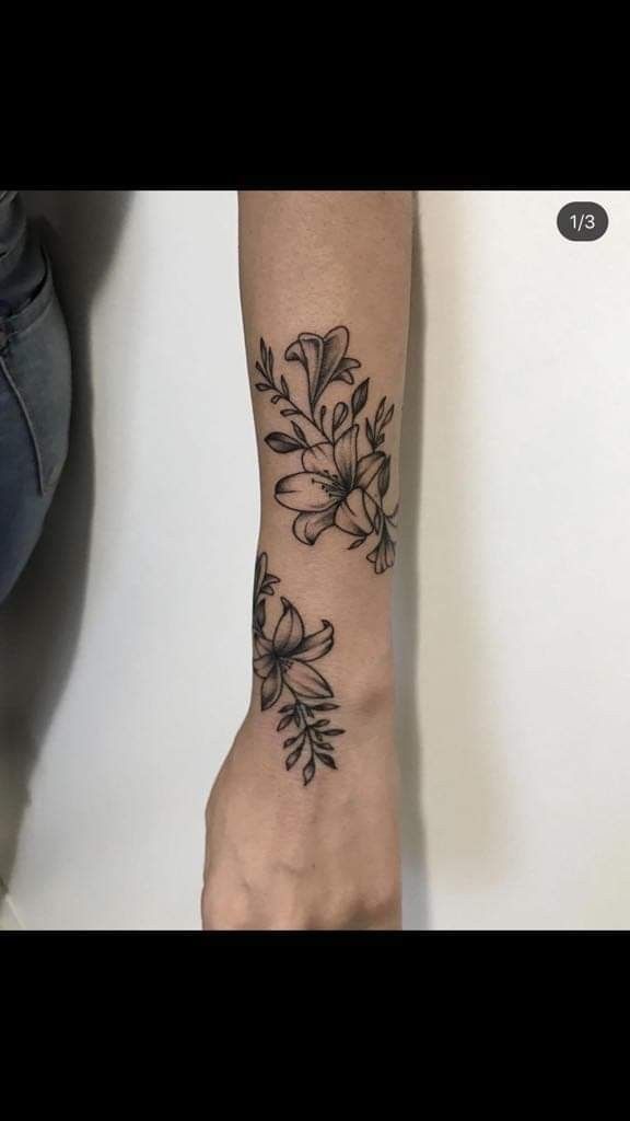 a woman's arm with flowers on it