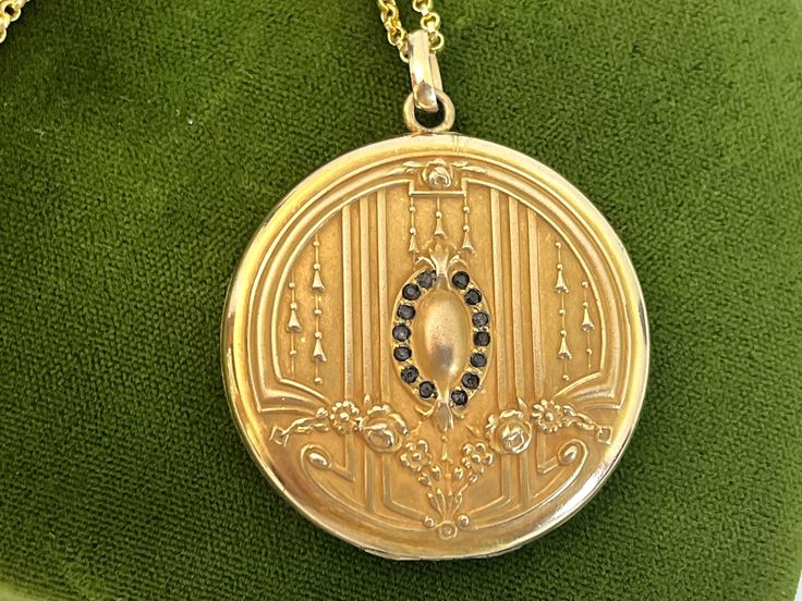 "Description: A large and lovely antique round Art Nouveau monogrammed gold filled photo locket on a new 14K gold filled chain.  The front of this locket made by the SB Company, features a central raised oval shape surrounded by a total of 14 \"paste\" stones. The stones that were probably once clear have darkened with age. There are 7 in paste gems on each side of the central oval. At the top and at the bottom of this oval shape is a raised fleur de lis. There are a total of 6 raised vertical l Round Art, Photo Locket, Antique Art Deco, Gold Filled Chain, Antique Art, Gold Style, Cut Glass, Estate Jewelry, Spring Rings