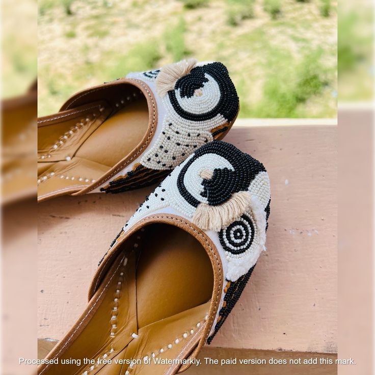 Handmade Jutti Size:- UK (Example:- if you wear US 7 Then Order UK 6) closure:- pull on Color:- black Material:- Leather Made:- Handmade Sole:- Leather Can Be Personalized:- Yes Crafted with exquisite artistry and cultural richness, our bridal shoes collection on Etsy embodies the timeless elegance of Indian traditional footwear. From Punjabi Juttis to bejeweled masterpieces, our range showcases an array of stunning designs perfect for every occasion. Adorned with intricate embellishments and sparkling details, our party wear shoes exude a graceful charm that seamlessly blends with contemporary fashion trends. Embrace the allure of our Punjabi Juttis, meticulously handcrafted with a blend of traditional artistry and modern finesse. Designed to reflect the vibrancy of Indian culture, these Traditional Black Closed Toe Heels, Traditional Closed Toe Leather Heels, Traditional Leather Closed Toe Heels, Traditional Embroidered Closed Toe Heels, Traditional Closed Toe Embroidered Heels, White Traditional Slip-on Flats, Traditional White Slip-on Flats, Bridal Shoes Indian, Holiday Party Shoes