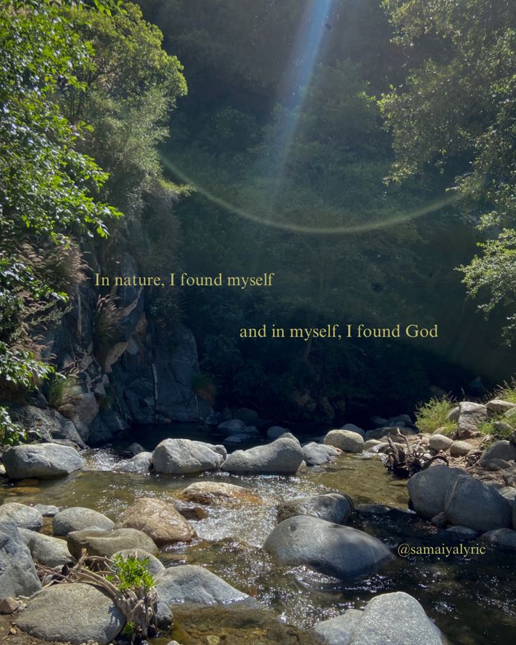 a river with rocks and trees in the background that says i'm nature i found myself and in mysel, i found god