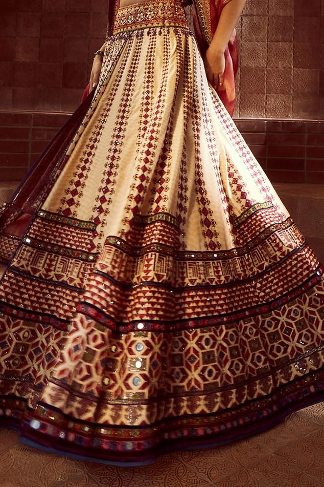 Multicoloured kalidar lehenga inspired by tribal patchwork and two stylised patkas in the front that is highlighted with intricate zardozi and aari embroidery and mirrorwork. Comes with mirror and resham-embroidered corset style blouse with stone fringes. Paired with a hand-printed dupatta with matching borders.
Component: 3
Pattern: Embroidered
Type Of Work: Mirror, Zardozi, Aari, Tribal Patchwork 
Neckline: Sweetheart
Sleeve Type: Sleeveless
Fabric: Lehenga-Silk Dupion , Blouse -Cambric, Dupat Bohemian Anarkali Set With Zari Work For Transitional Season, Transitional Bohemian Anarkali Set With Zari Work, Bohemian Sharara With Cutdana For Reception, Semi-stitched Anarkali Lehenga With Meenakari, Semi-stitched Silk Bohemian Sharara, Bohemian Semi-stitched Silk Sharara, Navratri Reception Anarkali Set, Anarkali Floor-length Choli With Cutdana, Bohemian Designer Anarkali Set For Festivals