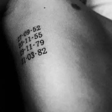 a person with a tattoo on their arm that has numbers and times printed on it