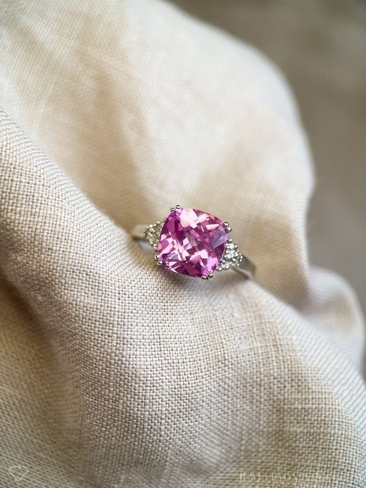 Classic Pink Cluster Ring For Anniversary, Classic Pink Cluster Ring With Prong Setting, Pink 14k White Gold Jewelry With Center Stone, Classic Rings With Pink Sapphire Center Stone, Classic Pink Sapphire Ring With Center Stone, Cushion Cut Pink Sapphire Gemstone Jewelry, Classic Pink Jewelry For Promise, Classic Pink Topaz Ring For Anniversary, Classic Pink Topaz Ring With Prong Setting