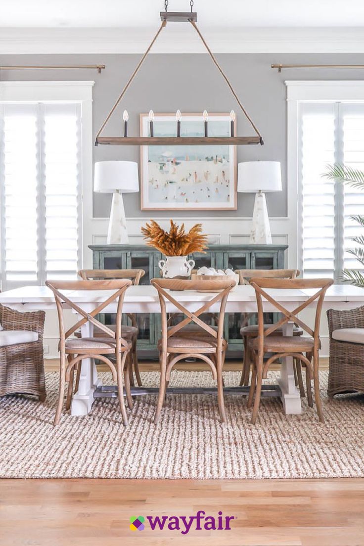 a dining room table with chairs and lamps