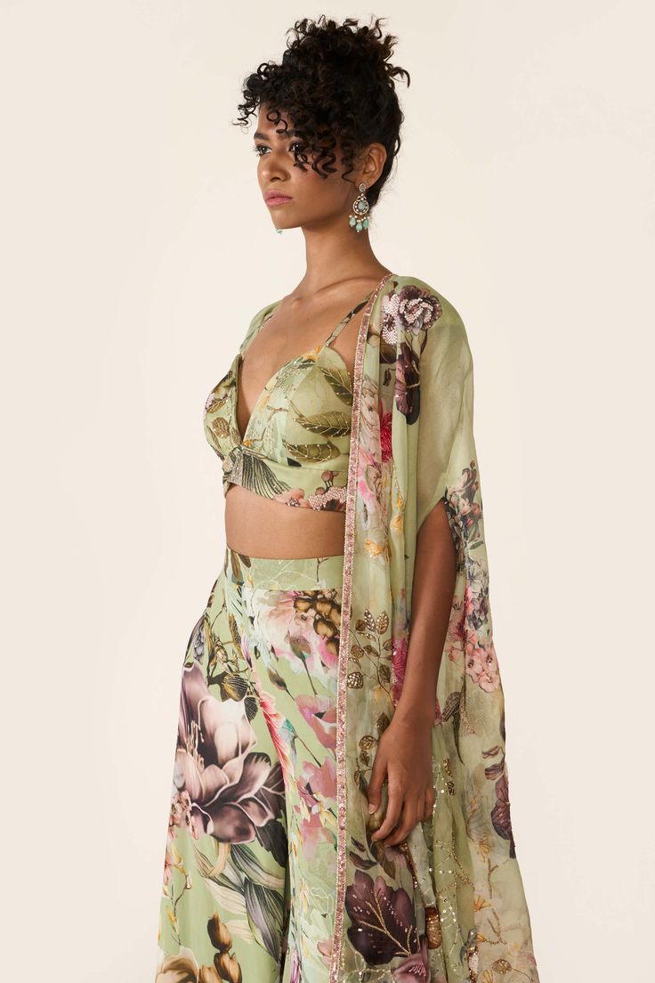 The green printed organza cape features sequin, cutdana and bead highlights with hand threadwork. It is paired with green printed bralette and trousers with thread work. Organza Cape, Varun Bahl, Embroidered Cape, Printed Organza, Palazzo Set, Vacation Style, Thread Work, Green Print, Aza Fashion