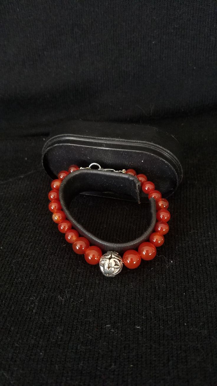 "This handmade Genuine Carnelian Beaded Bracelet was made on Silver Wire with round Genuine Carnelian Ball Beads. At each end are a 925 lobster clasp and jump ring. At the center is medium size Silver Ornate Metal Ball that is the focal point. This bracelet was handmade by Dulcinea for a small wrist and all items used are new. This bracelet will arrive in a gift box with FREE SHIPPING. Measure: 6 5/8\" L Material: Genuine Carnelian in Round Shape, 925 Lobster Clasp and Ornate Round Metal Ball Ha Adjustable Carnelian Beaded Bracelets With Gemstone Beads, Adjustable Carnelian Gemstone Beaded Bracelets, Adjustable Carnelian Beaded Bracelets As Gift, Carnelian Round Beads Bracelet For Gift, Carnelian Beaded Bracelets For Healing, Adjustable Carnelian Beaded Bracelets, Adjustable Carnelian Bracelet As A Gift, Adjustable Carnelian Bracelet Perfect For Gifts, Adjustable Carnelian Beaded Bracelets For Meditation