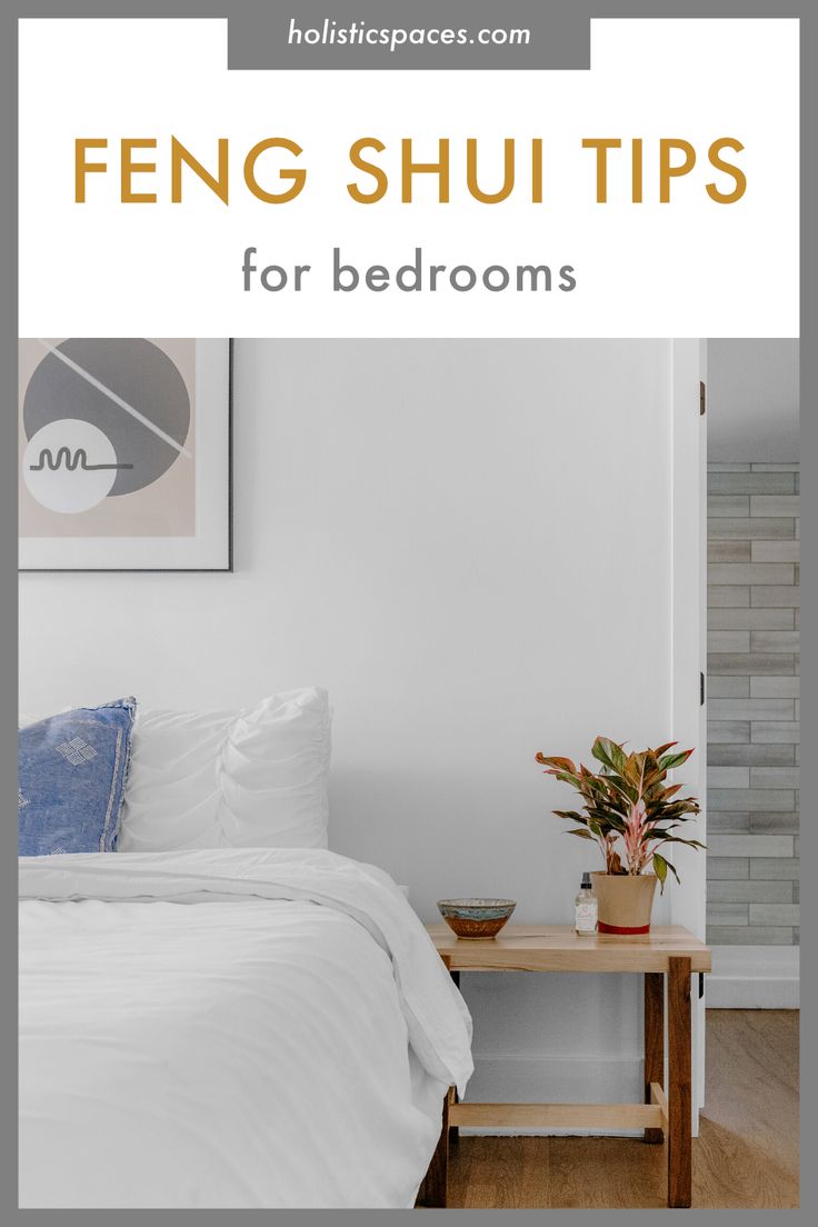 a bedroom with white walls and wood floors