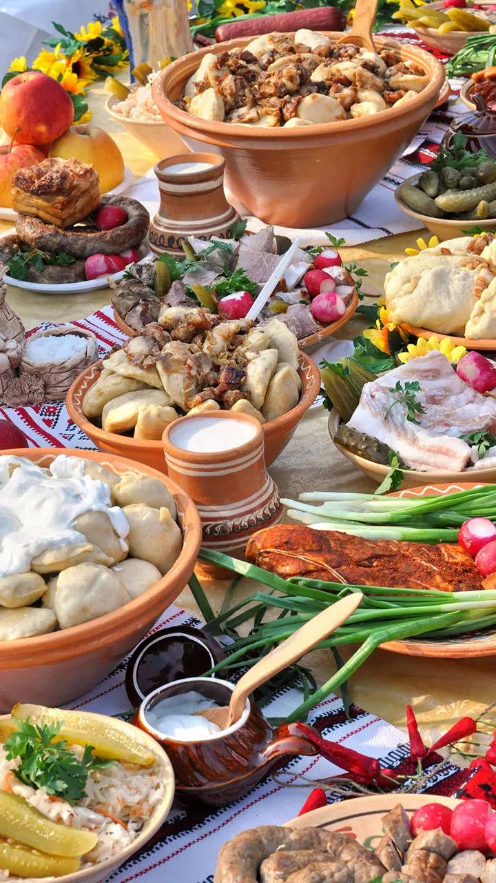 a table filled with lots of different types of food on it's plates and bowls