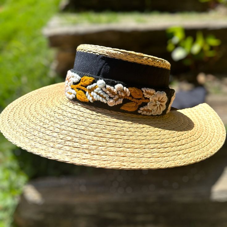 Our Mexican, high quality Artisal Palm Hat, comes with a removable hand embroidered band.  The band is embroidered by Female Artisans of the Andes in Perú.  This classic wide brim hat has sturdy weave to be used in the beach and all adventures in the sun.  Great sun protection.  The close-weave material in this product offers UPF 50+ which blocks 97.50% of the sun's UV rays. Hat Brim measures 4 3/4" wide Crown of hat measures 3 3/4" tall One size Bohemian Adjustable Sun Hat For Garden Party, Adjustable Bohemian Sun Hat For Garden Party, Adjustable Handwoven Boater Hat With Flat Brim, Handwoven Adjustable Boater Hat With Flat Brim, Summer Brimmed Hats With Embroidery, Summer Embroidered Short Brim Hat, Embroidered Summer Hat With Short Brim, Handmade Adjustable Sun Hat For Garden Party, Summer Wide Brim Embroidered Hats