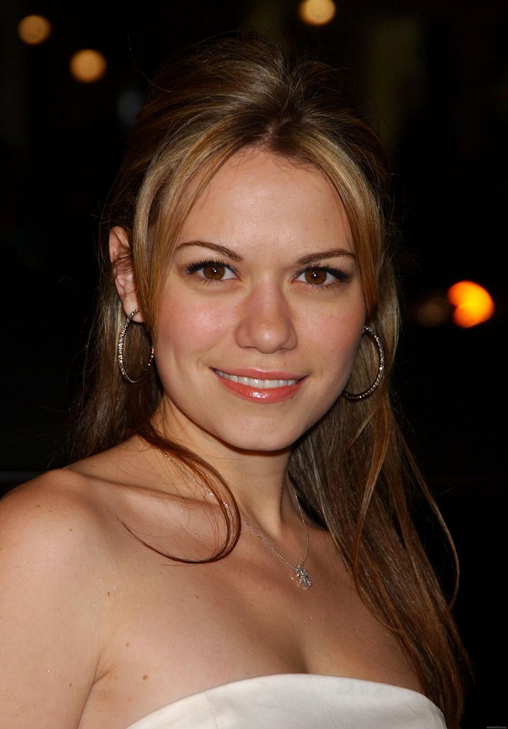 a beautiful young woman in a strapless white dress