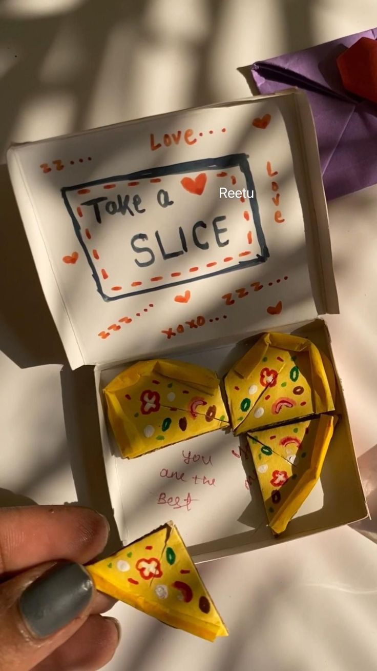 someone is holding two dices in a box with the word take a slice on it