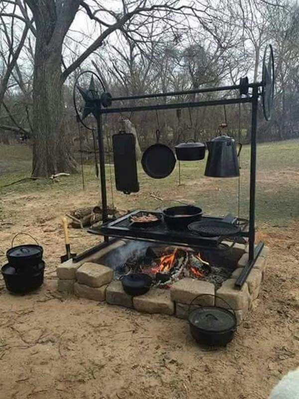 a fire pit with pots and pans on it