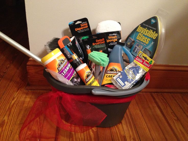 a bucket filled with cleaning supplies on top of a wooden floor