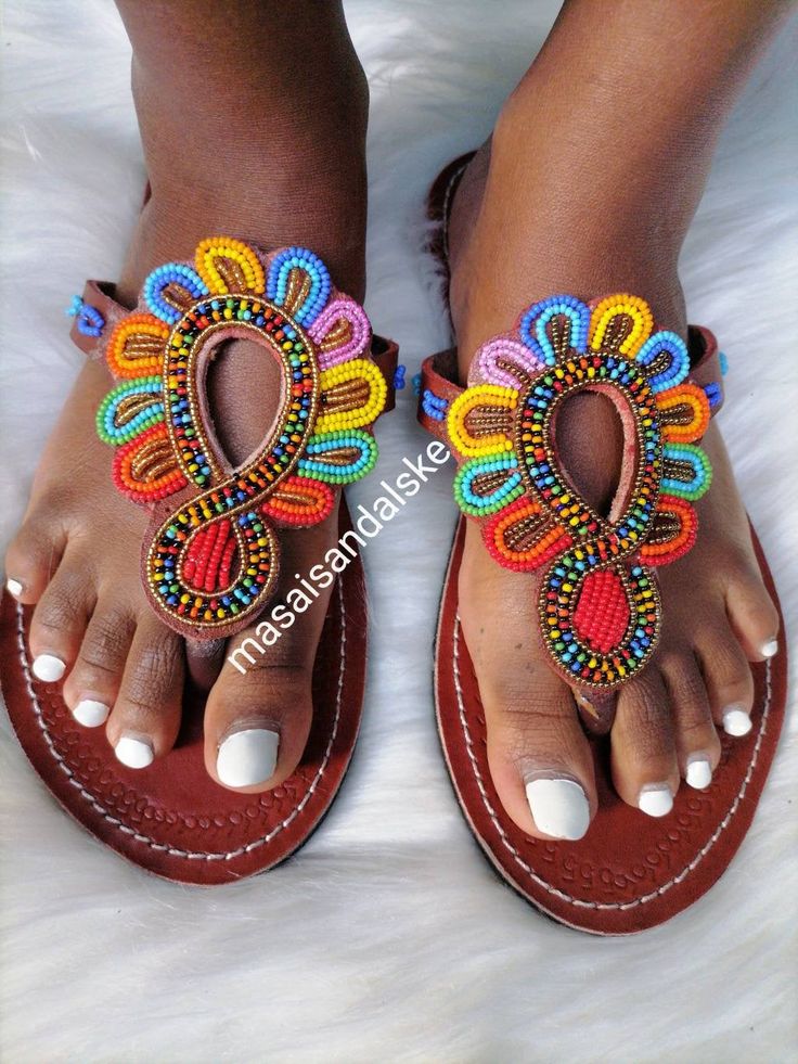 Maasai sandals is a unique simple beaded sandals made from real leather and has perfect flower made from Fines beads. Why you need the sandals? -it's light and durable hence it can be used during walk in the park, weekend outings, birthday party, beach party, working indoors and even driving since it's offers your feet enough ventilation and always stays fresh. -it's multicolored hence you won't be having problems of colour clashing. - it has a soft leather on the inner part which reduces fricti Bohemian T-strap Sandals With Ankle Strap, Bohemian T-strap Sandals For Beach, Bohemian T-strap Sandals With Round Toe, Adjustable Sandals For Festivals, Handmade Brown Sandals For Summer, Bohemian Beaded Sandals For Vacation, Handmade Open Toe T-strap Sandals For Spring, Bohemian T-strap Sandals For Spring Festival, Bohemian T-strap Sandals For Spring