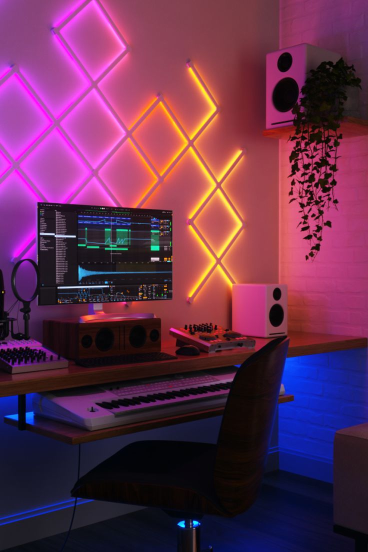 A music studio desk setup decorated with Nanoleaf Lines 90 Degrees which emit pink, orange, and yellow colors in the first image, and pink, orange, yellow, and blue colors in the second image Led Music Studio, Dj Setup Aesthetic, Bedroom Studio Music, Livestream Setup, Powerbi Dashboard, Music Studio Lighting, Studio Setup Ideas, Small Music Room, Home Music Studio Design