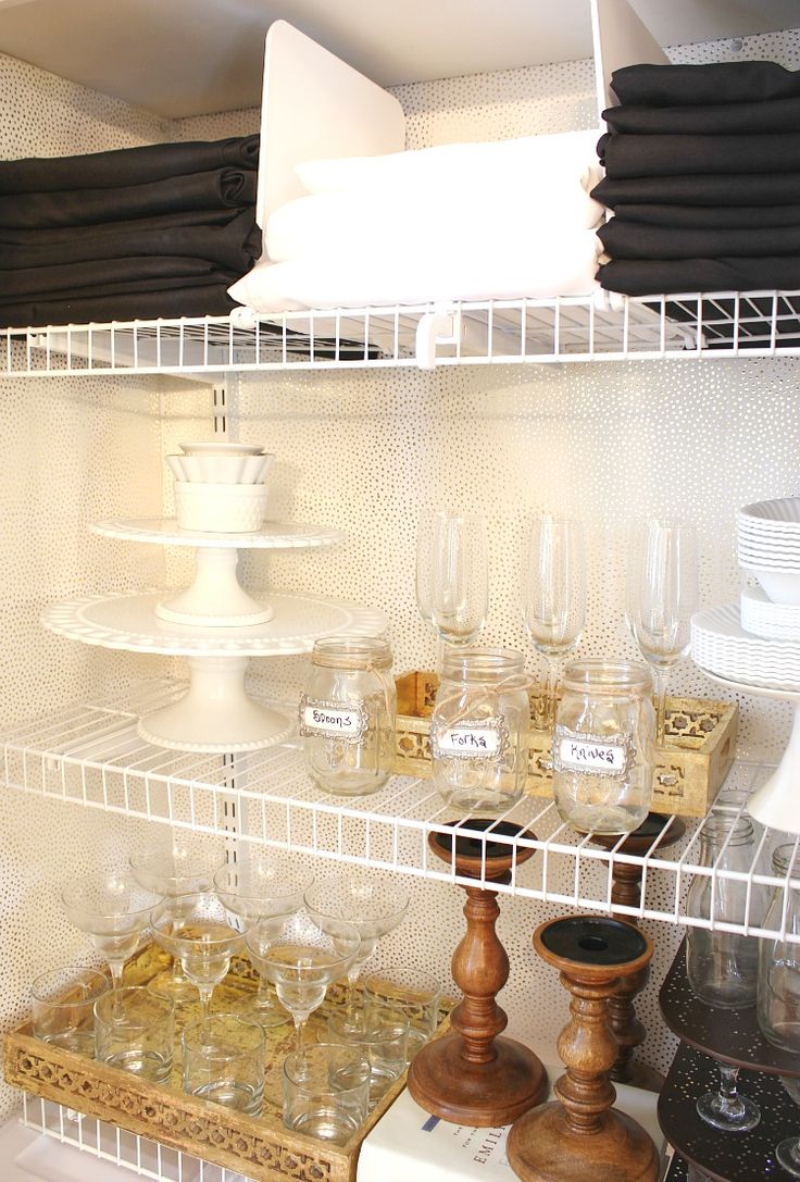 the shelves are filled with glasses and dishes