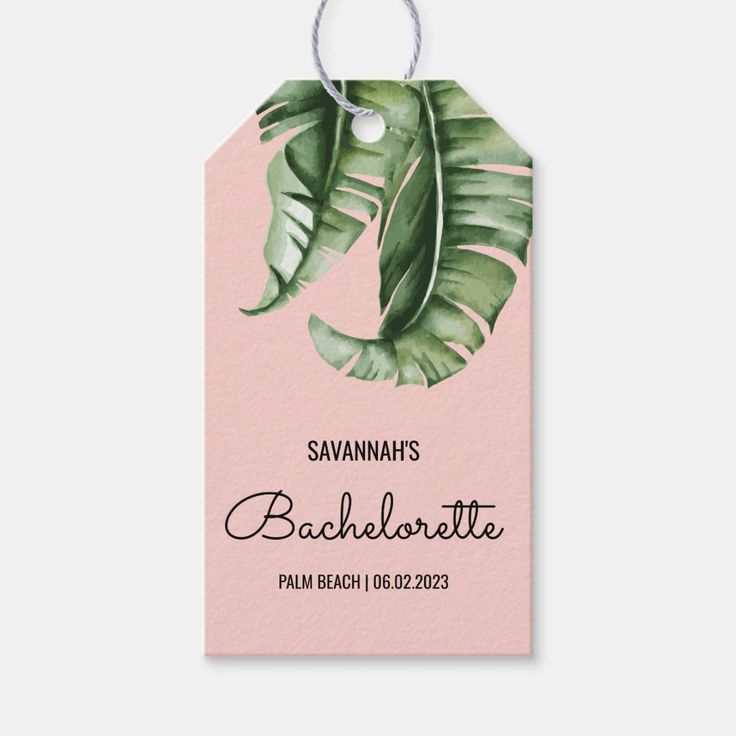 a pink gift tag with a green leaf on it