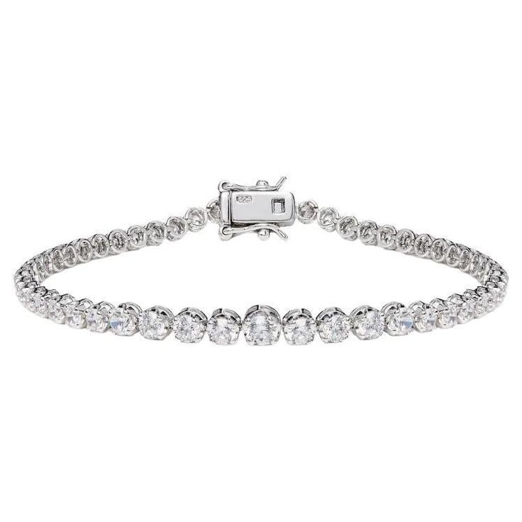 This dazzling claw set graduating round brilliant cut cubic zirconia tennis bracelet is a sparkling addition to any outfit. Featuring 4.56ct of round brilliant cut cubic zirconia set in 925 sterling silver with a high gloss white rhodium finish. Whether you're looking for a classic piece to add to your jewellery box, or something totally on-trend, designers Lustre of London believe that every woman should have the chance of owning exquisite designer jewelry, for that extra sparkle and glamour. L Silver Diamond Round Cut Tennis Bracelet, Luxury Adjustable Round Cut Tennis Bracelet, Luxury Silver Round Cut Tennis Bracelet, Luxury Cubic Zirconia Round Cut Tennis Bracelet, Luxury White Round Cut Tennis Bracelet, Bracelet Tennis, Antique Bracelets, Diamond Simulant, Tennis Bracelet Diamond