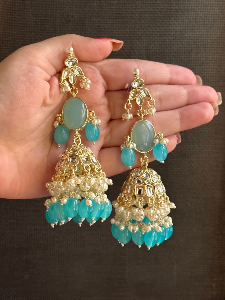 These light weight long blue kundan statement earrings are the perfect addition to any traditional outfit. featuring a big central stone and a Jhumka, these earrings are unique and sure to make a statement. they are high quality but still easy on your ears to wear as they feel very light weight.  also available in a beautiful yellow colour!  shop now! for any queries, please feel free to reach out to us. Blue Jhumka, Teal Jewelry, Pretty Jewelry Necklaces, Traditional Outfit, Fancy Jewellery Designs, Indian Jewelry Sets, Kundan Earrings, Yellow Colour, Wedding Accessories Jewelry