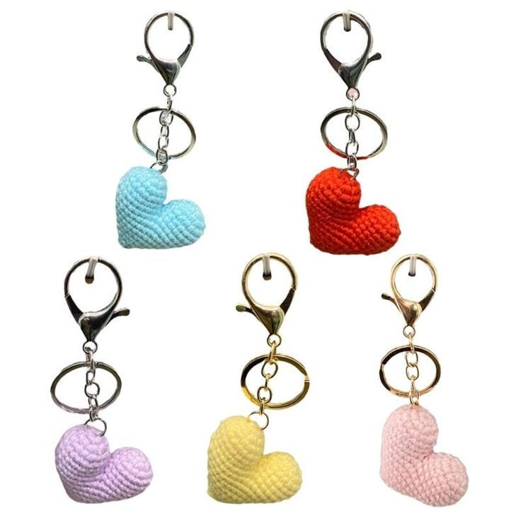 four heart shaped key chains are shown in different colors and sizes, with two hearts attached to them