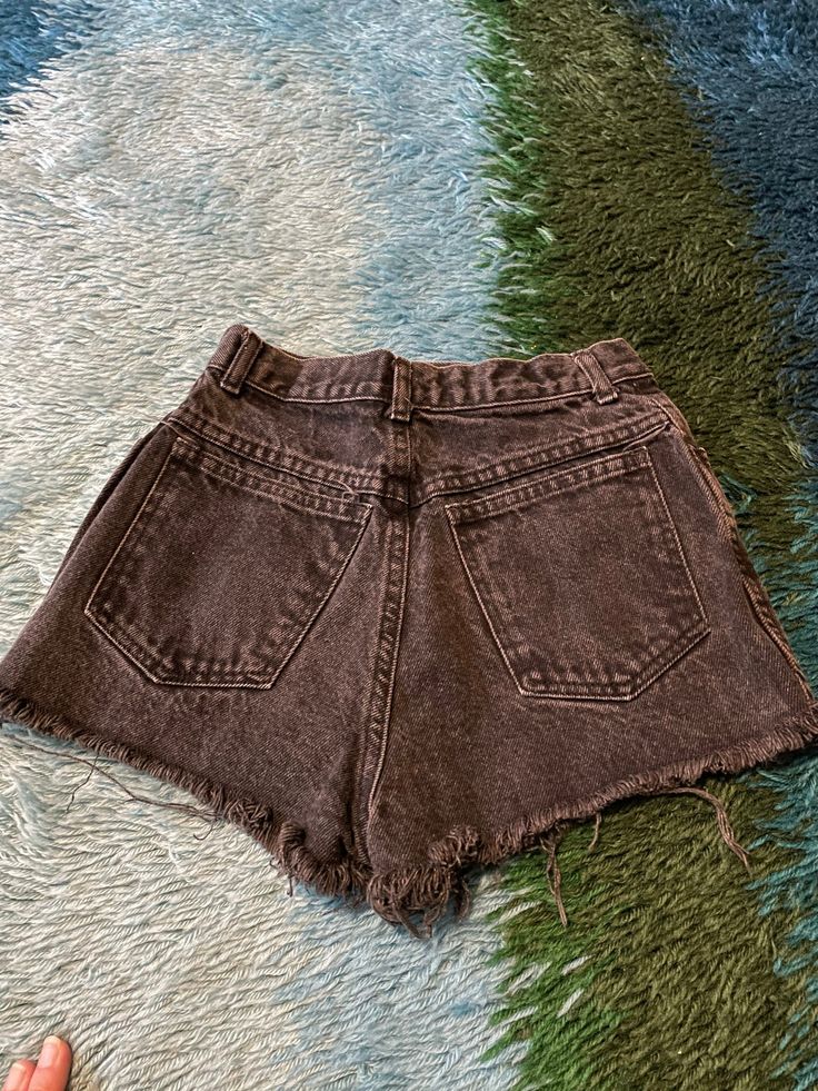 "I wish I could pull these off! Best faded black 90's high waisted black denim shorts. Frayed hem and cheeky bottom. Waist: 24\" Hips: 34\" Rise: 12\" Model is 5'7\" and 115 lbs with measurements of 30x23x33. Buy with confidence as all outside photos are taken in natural lighting" Grunge Jean Shorts With Built-in Shorts, Grunge Jean Shorts With Pockets, Grunge High Waist Jean Shorts With Built-in Shorts, Grunge High Rise Shorts With Pockets, High Waist Grunge Shorts For Streetwear, Grunge High Waist Shorts For Streetwear, Mid-rise Grunge Shorts For Streetwear, Grunge Mid-rise Shorts For Streetwear, High Rise Washed Black Grunge Bottoms