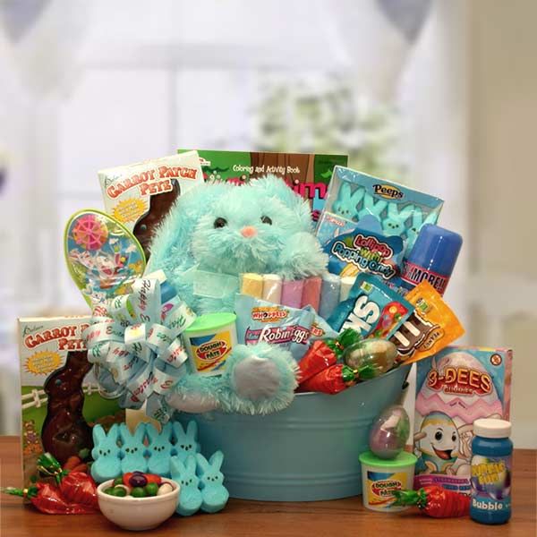 a blue bucket filled with lots of toys and candys on top of a white table