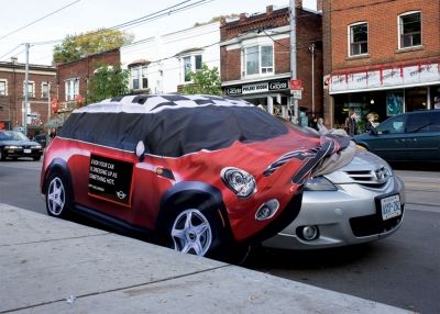 an unusual car is parked on the side of the street