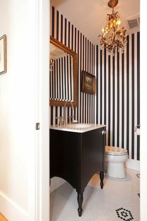 the bathroom is decorated in black and white stripes