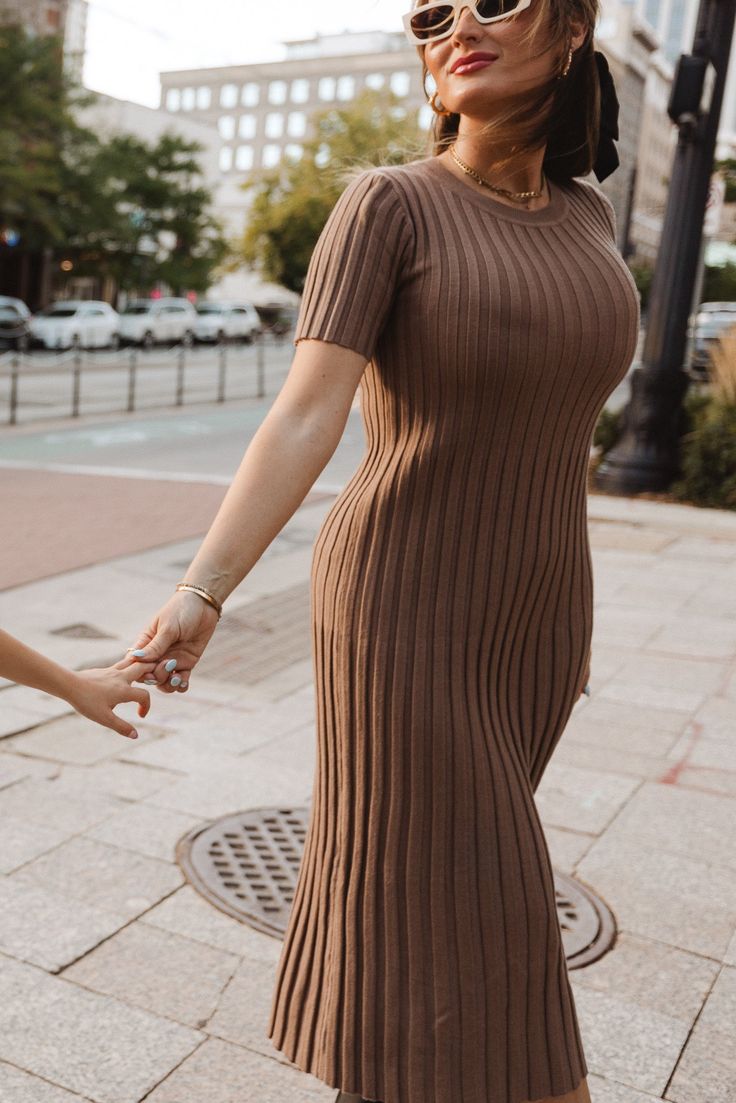 The perfect addition to your fall wardrobe is here - the Alexa Dress in Taupe! Made from a soft and comfortable taupe knit fabric, this modest women's dress features a round neckline and short fitted sleeves. The midi-length skirt and pull-over style make it both stylish and easy to wear. Plus, it's maternity friendly! Brown Ribbed Midi Sweater Dress, Ribbed Stretch Midi Dress With Short Sleeves, Stretch Ribbed Midi Dress With Short Sleeves, Modest Short Sleeve Dresses For Fall, Fall Midi Dress With Short Sleeves, Fitted Brown Midi Sweater Dress, Fitted Brown Midi Length Sweater Dress, Modest Knee-length Stretch Midi Dress, Brown Ribbed Stretch Midi Dress