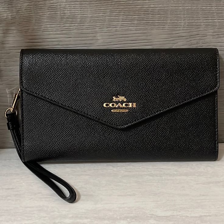 Nwt Coach Travel Envelope Wallet Details: Crossgrain Leather Five Credit Card Slots Id Window Inside Zip And Open Pockets Snap Closure Outside Zip Coin Pocket Detachable Wrist Strap 8 1/4" (L) X 4 1/2" (H) Black Envelope Clutch With Card Slots, Elegant Envelope Wallets For Daily Use, Elegant Envelope Wallets For Everyday Use, Chic Envelope Travel Wallet, Elegant Envelope Wallet For Everyday Use, Chic Travel Envelope Wallet, Black Business Wallet On Chain Clutch, Black Business Clutch Wallet On Chain, Black Wallet On Chain For Business